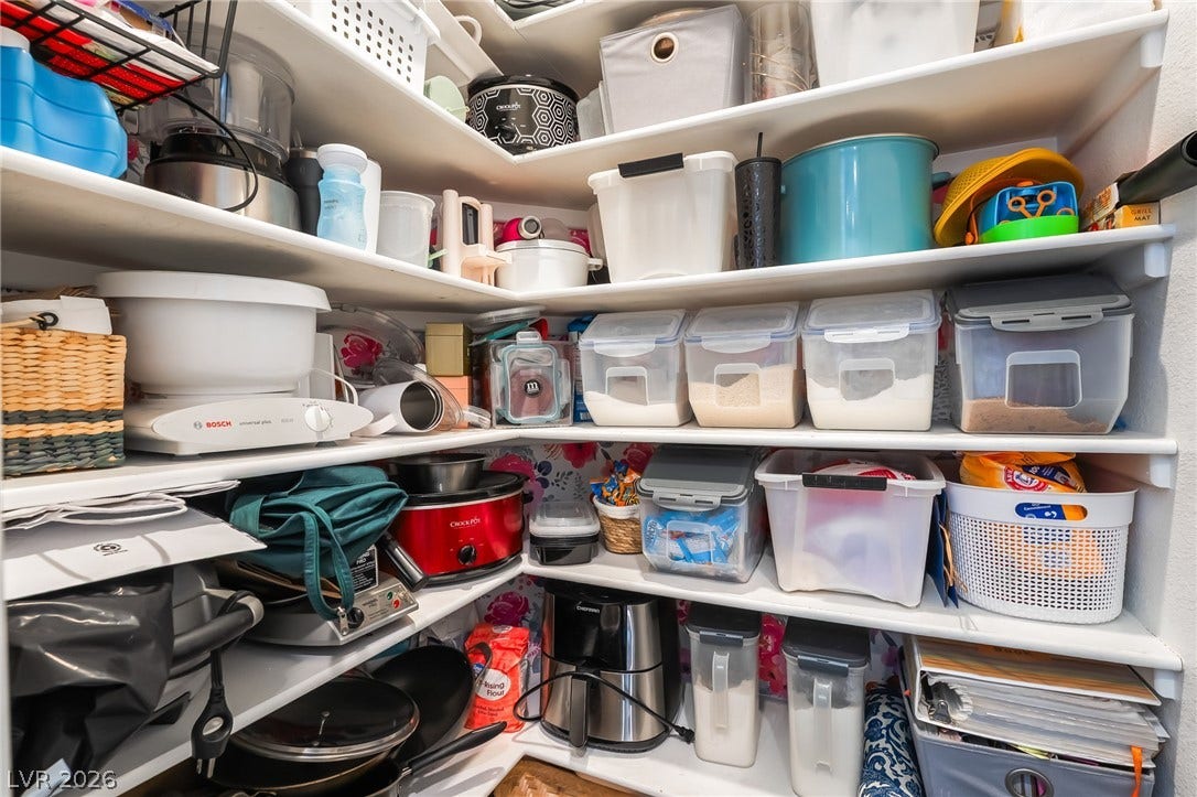 1892 Woodhaven Drive, Henderson, NV 89074 Organized pantry shelves offer ample storage solutions for kitchen essentials and small appliances.
