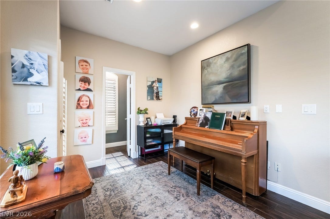 1892 Woodhaven Drive, Henderson, NV 89074 Rich hardwood floors complement this cozy living space, perfect for music and relaxation.