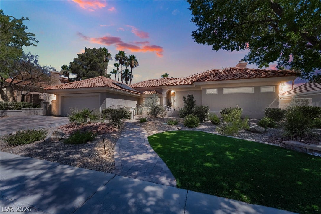 1892 Woodhaven Drive, Henderson, NV 89074 A terracotta-tiled roof and stucco exterior complement the desert landscaping and inviting paver walkway.