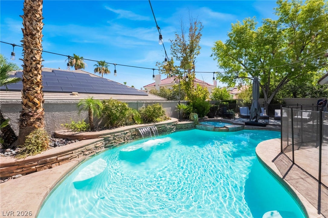 1892 Woodhaven Drive, Henderson, NV 89074 A tranquil oasis awaits, complete with a sparkling pool, soothing spa, and cascading waterfall.