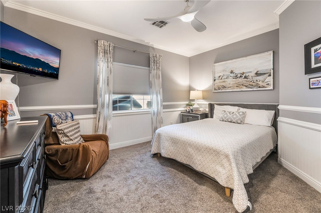 1892 Woodhaven Drive, Henderson, NV 89074 Relax in this tranquil bedroom, featuring a contemporary ceiling fan and elegant crown molding.