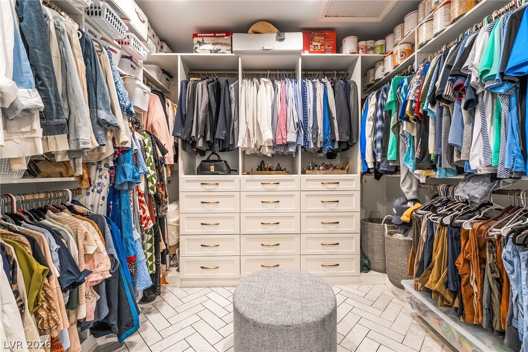 1892 Woodhaven Drive, Henderson, NV 89074 Walk-in closet featuring extensive built-in cabinetry, shelving, and hanging space for an organized wardrobe.