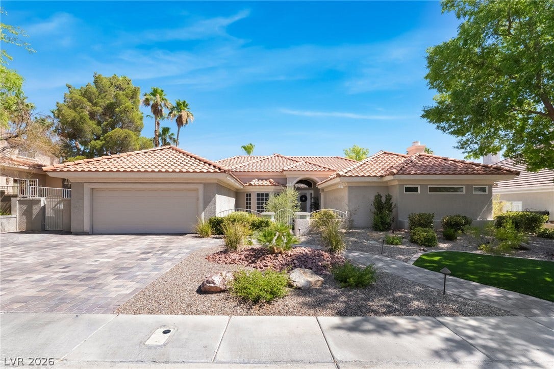 1892 Woodhaven Drive, Henderson, NV 89074 A well-maintained facade with Mediterranean roofing and a paver driveway welcomes you home.