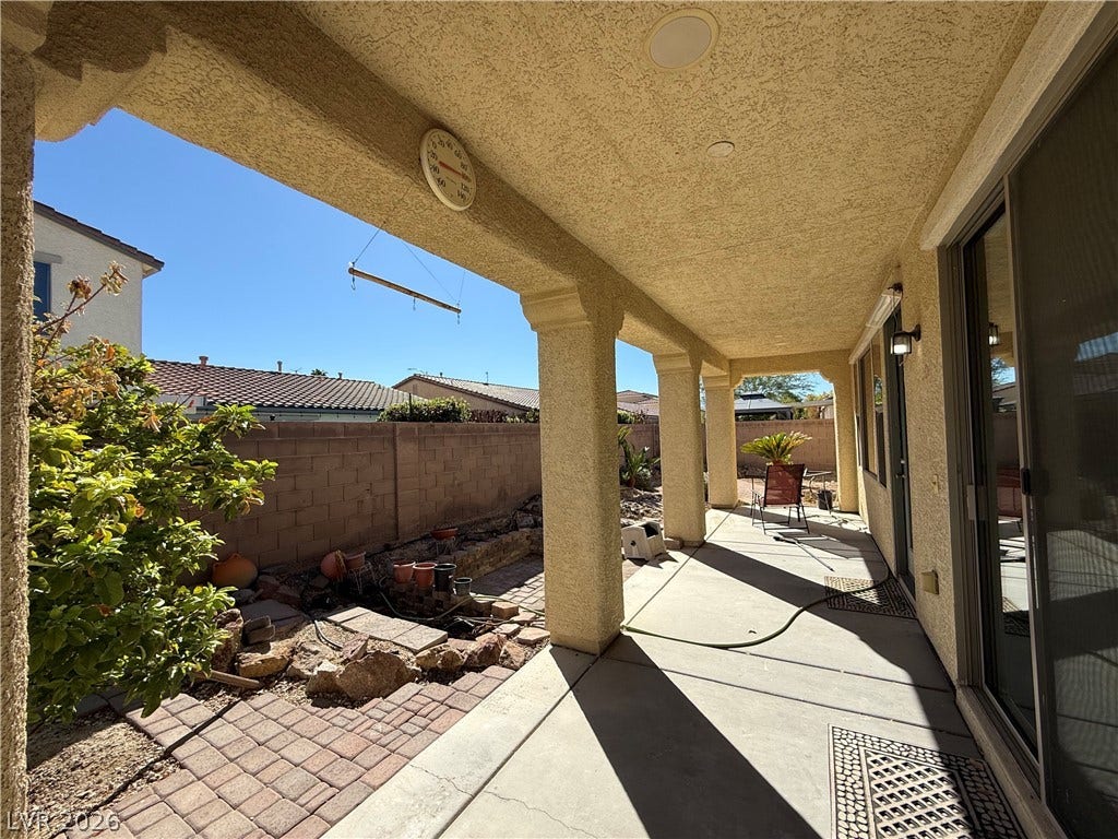 4327 Oasis Hill Avenue, North Las Vegas, NV 89085 Shaded concrete patios provide comfortable outdoor living spaces alongside low-maintenance desert landscaping.