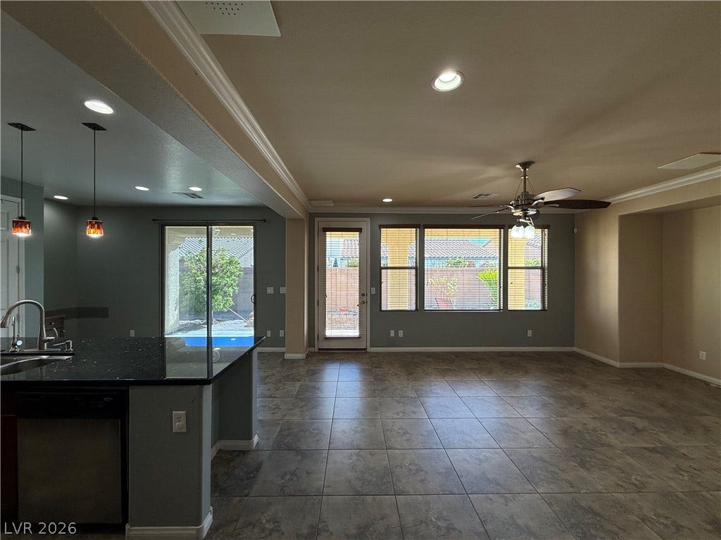 4327 Oasis Hill Avenue, North Las Vegas, NV 89085 Tile flooring and an open layout connect the kitchen to a spacious living area.