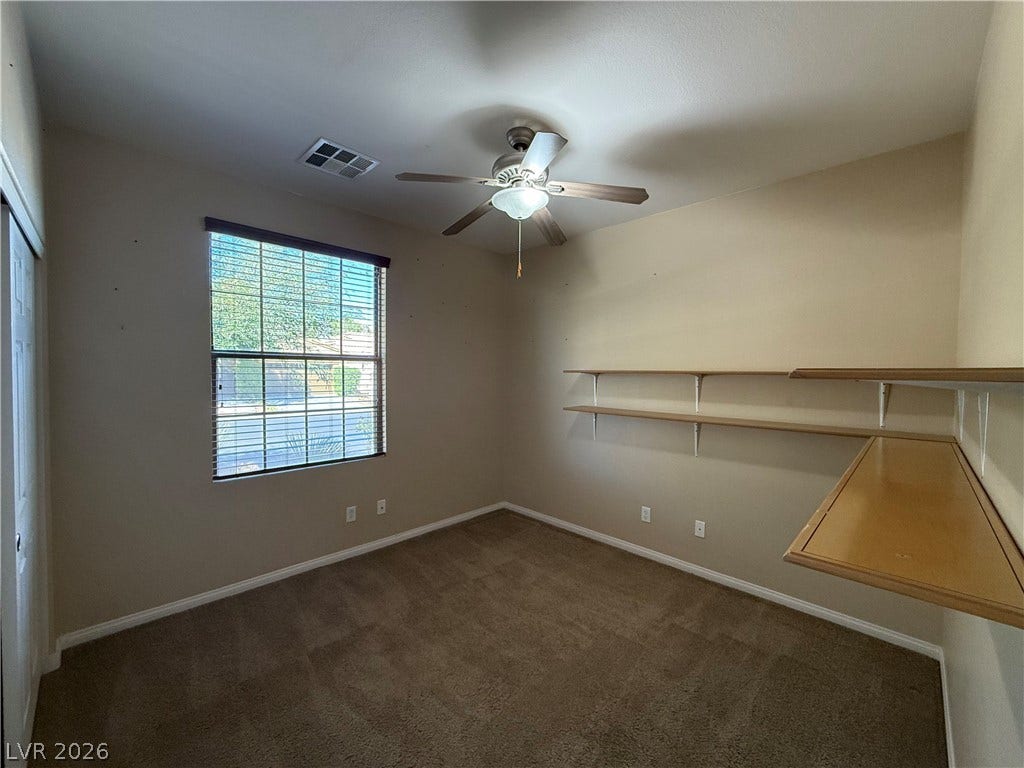 4327 Oasis Hill Avenue, North Las Vegas, NV 89085 A versatile room showcases built-in wall shelving and comfortable wall-to-wall carpeting.