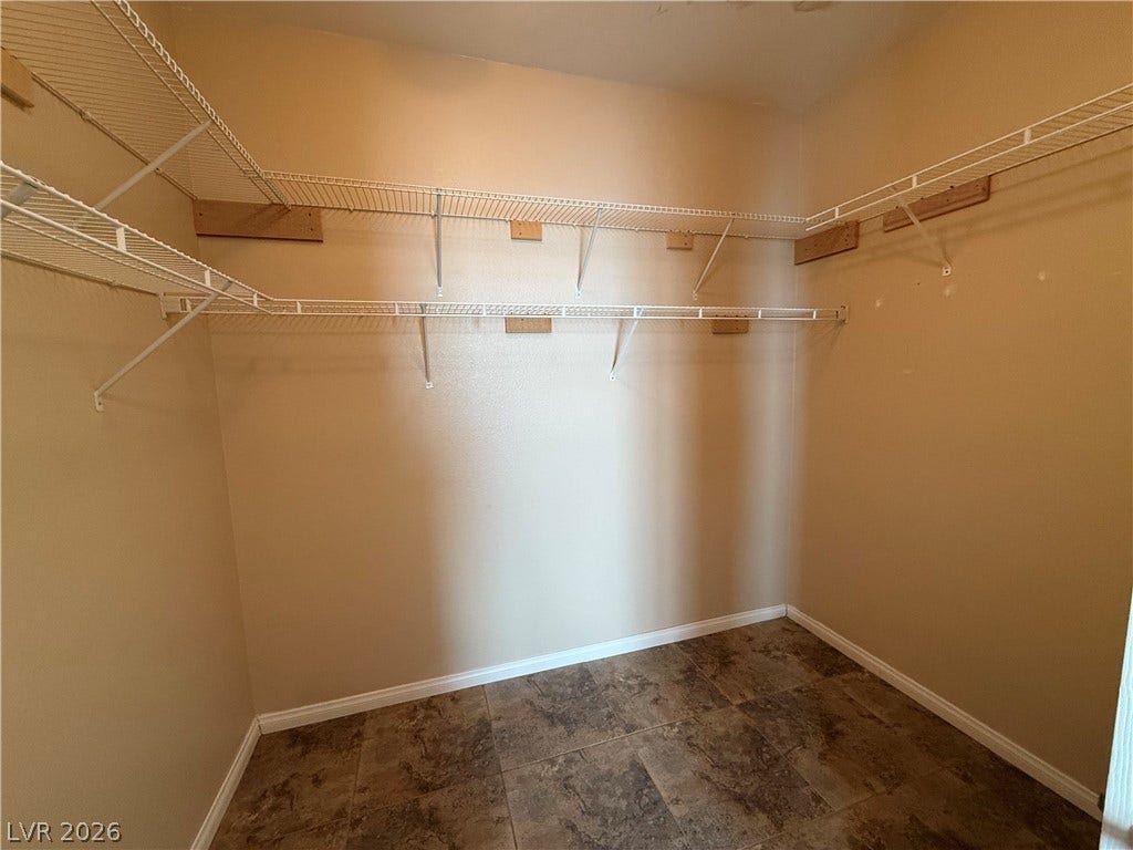 4327 Oasis Hill Avenue, North Las Vegas, NV 89085 Ample wire shelving units maximize storage capacity in this walk-in closet with durable tile flooring.