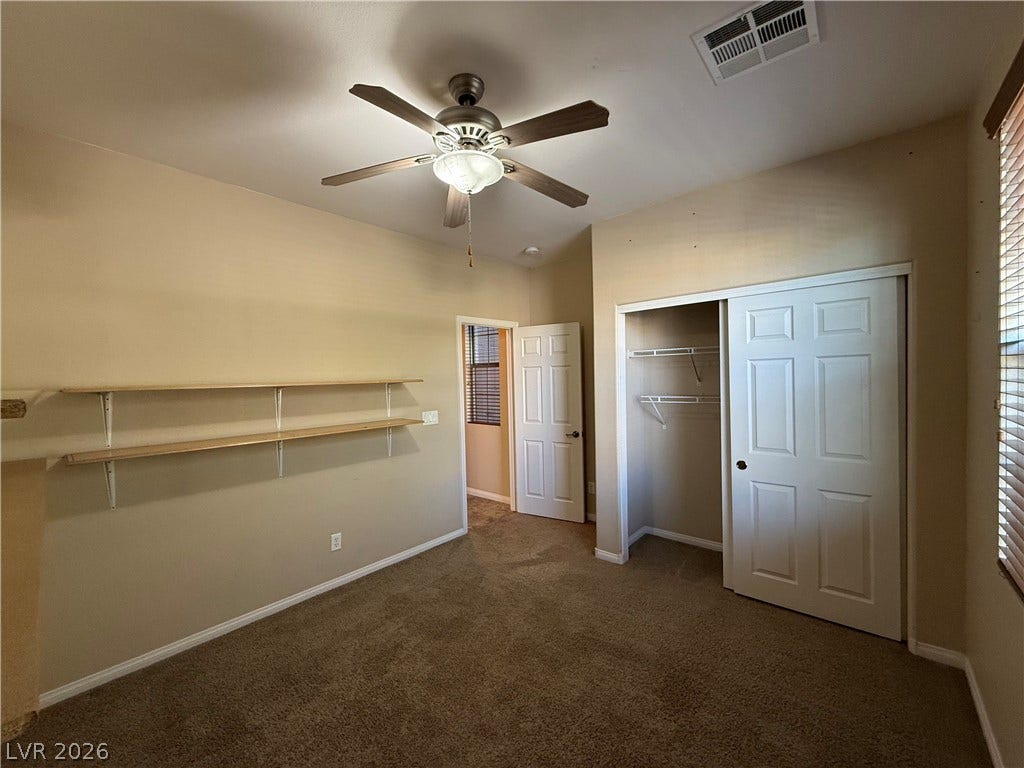 4327 Oasis Hill Avenue, North Las Vegas, NV 89085 Plush carpeting anchors this versatile room containing built-in wall shelving and a spacious closet.