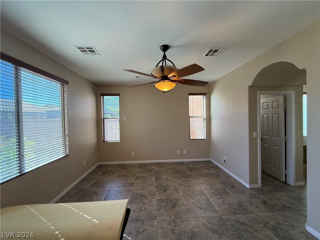 4327 Oasis Hill Avenue, North Las Vegas, NV 89085 Tiled flooring and natural light from multiple windows define this versatile living area.