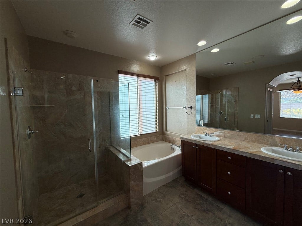 4327 Oasis Hill Avenue, North Las Vegas, NV 89085 Granite counters and a separate soaking tub create a spa-like feel in this bathroom.