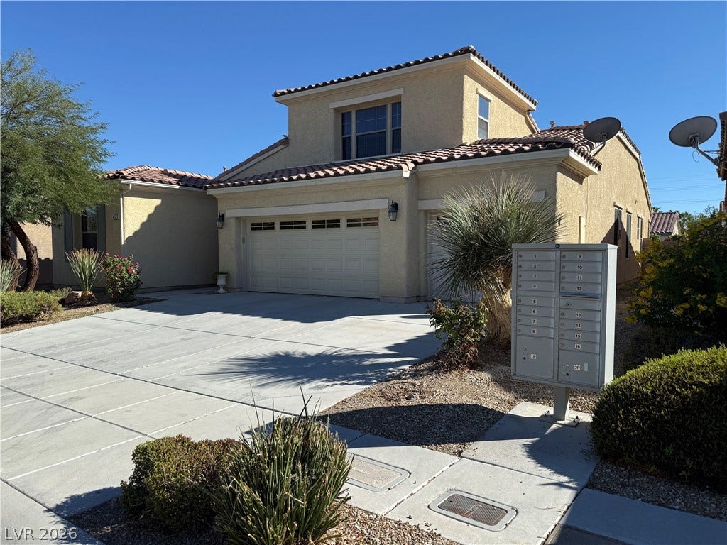 4327 Oasis Hill Avenue, North Las Vegas, NV 89085 Spanish tile roofing and stucco siding accent the exterior of this multi-level suburban residence.