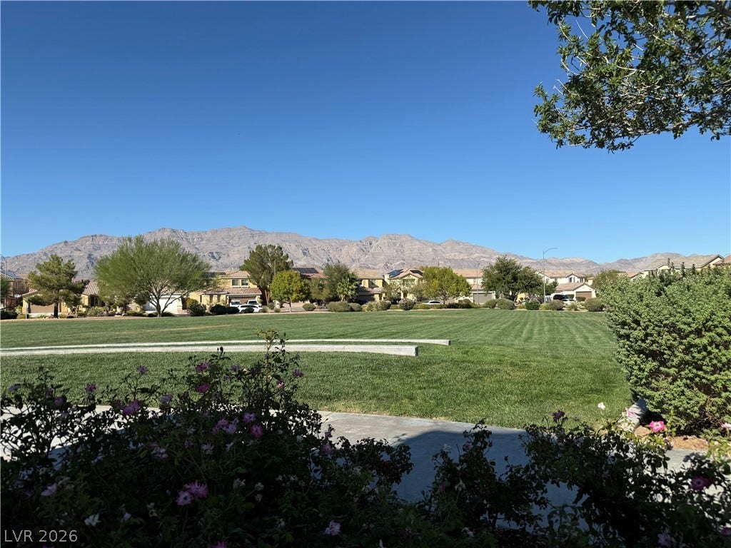 4327 Oasis Hill Avenue, North Las Vegas, NV 89085 Majestic mountain ridges frame the manicured green space bordering this desert landscape.