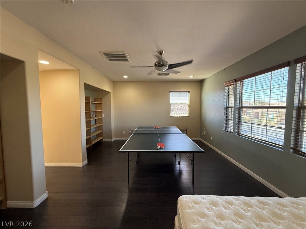 4327 Oasis Hill Avenue, North Las Vegas, NV 89085 Rich dark wood flooring anchors this versatile space flanked by abundant windows.