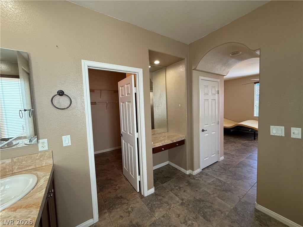 4327 Oasis Hill Avenue, North Las Vegas, NV 89085 An arched entryway connects this functional bathroom suite to the adjoining bedroom.