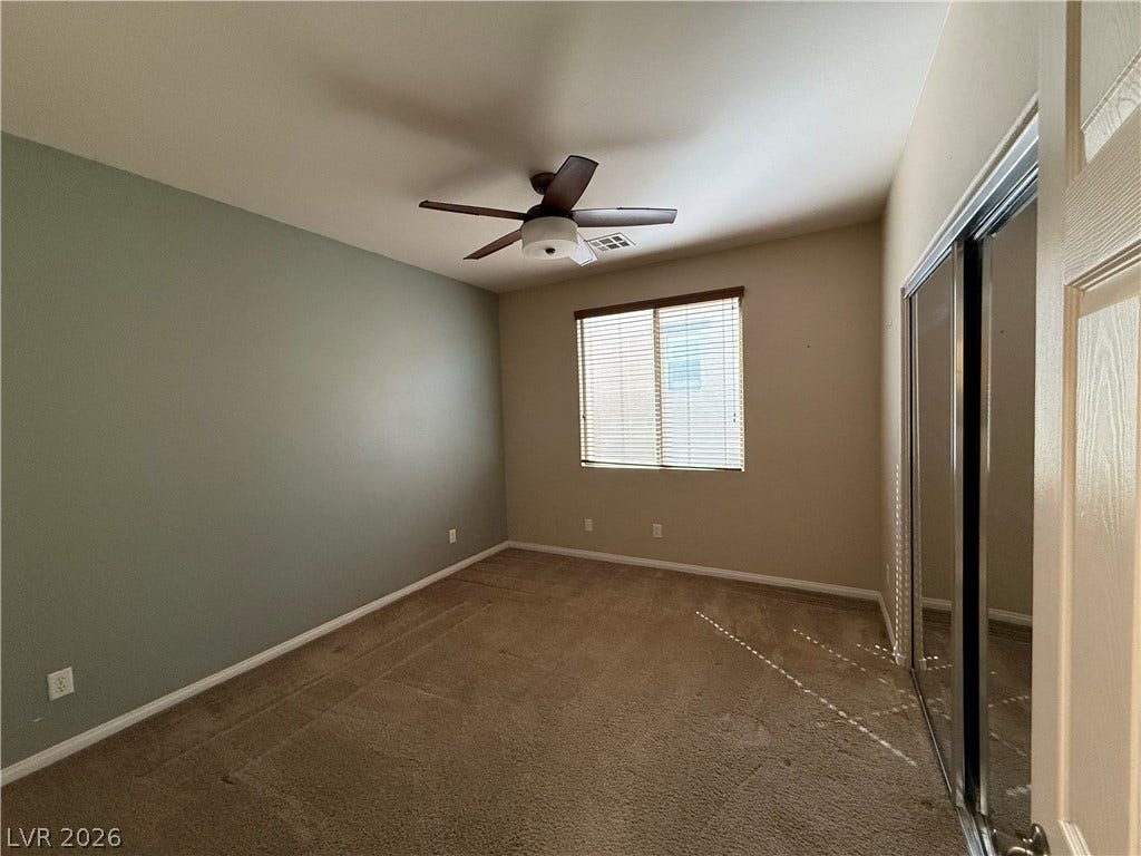 4327 Oasis Hill Avenue, North Las Vegas, NV 89085 Plush carpeting and mirrored sliding closet doors complete this comfortable guest bedroom layout.