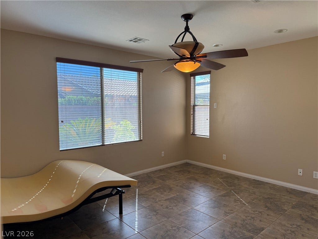 4327 Oasis Hill Avenue, North Las Vegas, NV 89085 Durable tile flooring and dual windows highlight this versatile bedroom space.