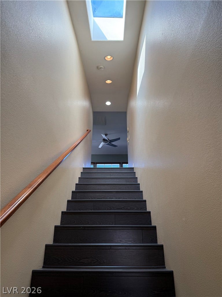 4327 Oasis Hill Avenue, North Las Vegas, NV 89085 Rich dark wood steps ascend toward a sky-lit ceiling with modern recessed lighting.