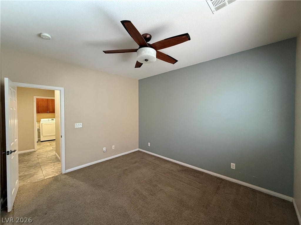 4327 Oasis Hill Avenue, North Las Vegas, NV 89085 Plush carpeting underfoot anchors this versatile bedroom space with convenient nearby laundry access.