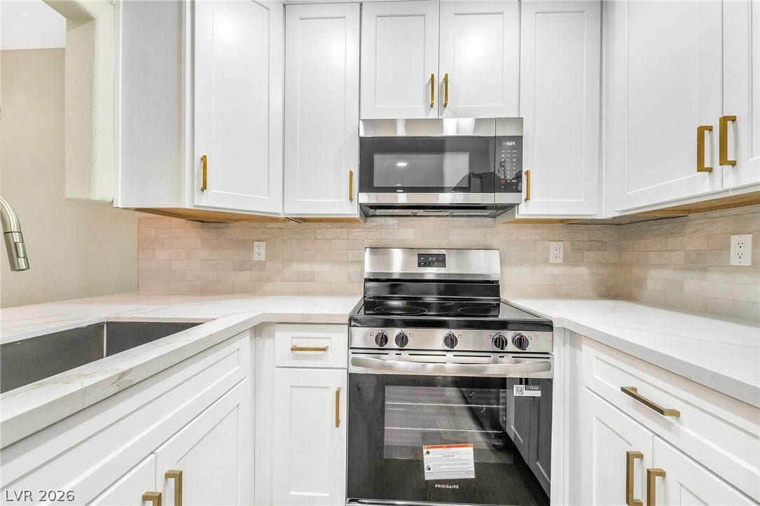 601 Cabrillo Circle, #431, Henderson, NV 89015 Crisp cabinetry and stone countertops frame the modern cooking area in this workspace.