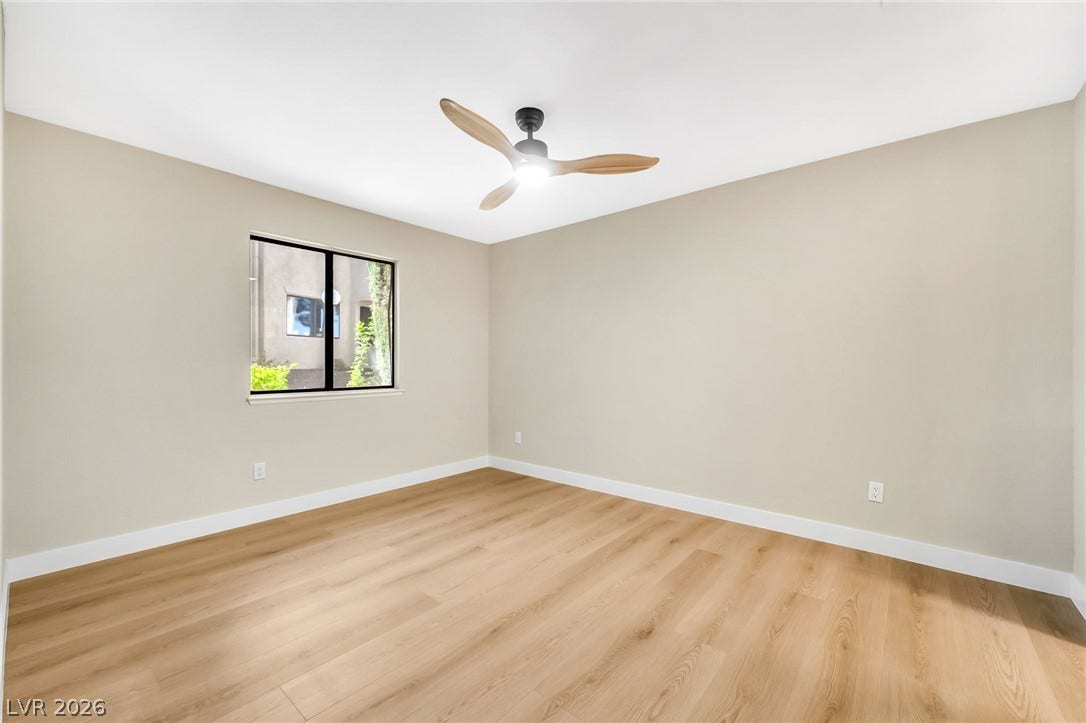 601 Cabrillo Circle, #431, Henderson, NV 89015 Smooth wood floors and tall white baseboards anchor this inviting, neutral-toned room.