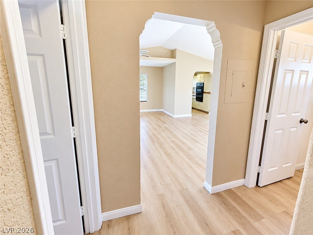 1417 Santa Margarita Street, #G, Las Vegas, NV 89146 An arched doorway transitions smoothly from the entry hall into the spacious main living areas.