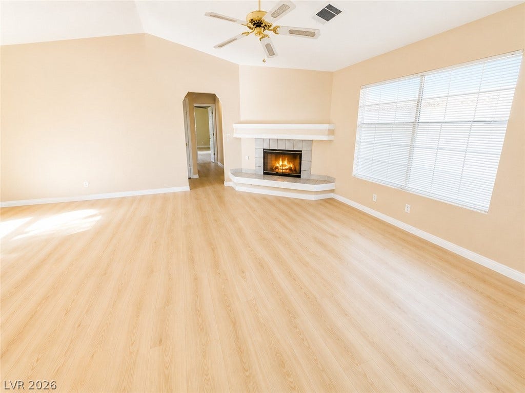 1417 Santa Margarita Street, #G, Las Vegas, NV 89146 Warm vinyl flooring and a classic corner fireplace ground this spacious, high ceilings light-filled living area.