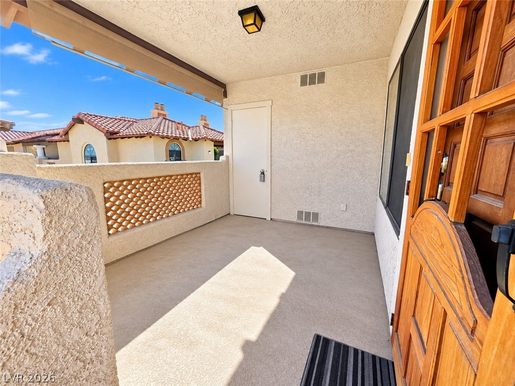 1417 Santa Margarita Street, #G, Las Vegas, NV 89146 A private covered entryway features textured stucco walls and durable concrete flooring. water heater closet