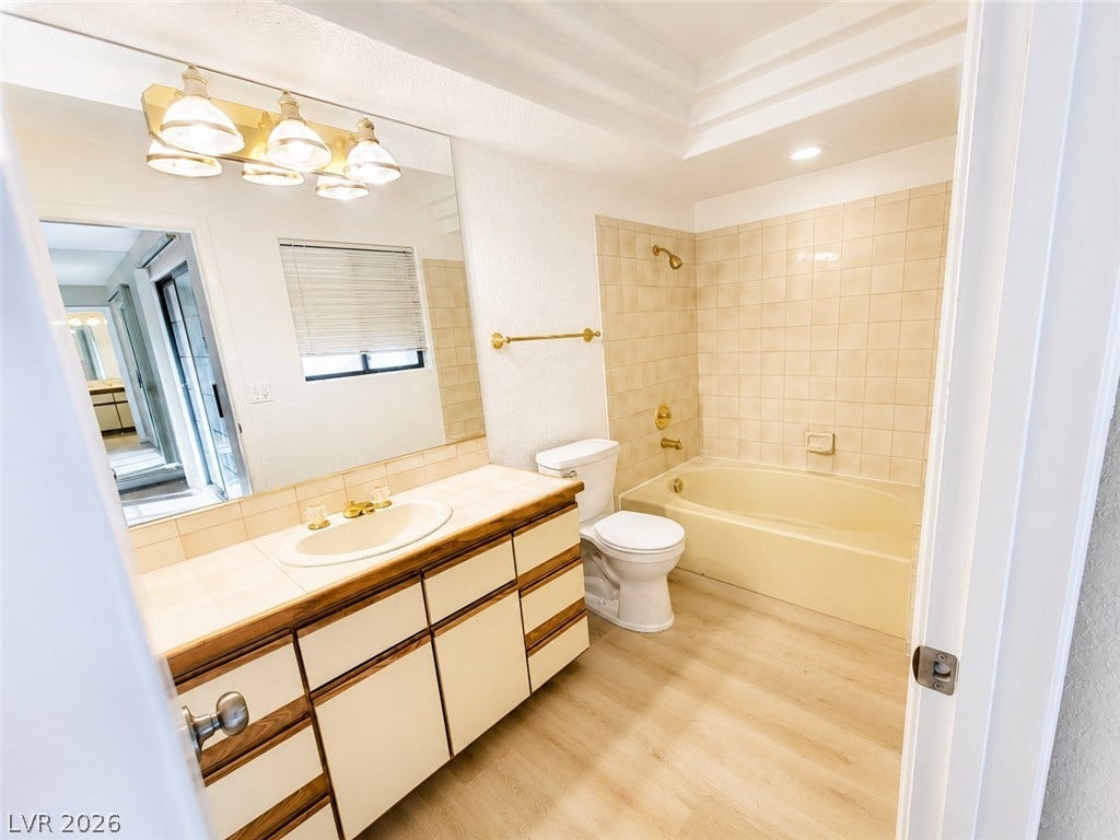1417 Santa Margarita Street, #G, Las Vegas, NV 89146 A spacious vanity and tile-surround bathtub new toilet anchor this bright primary bathroom.