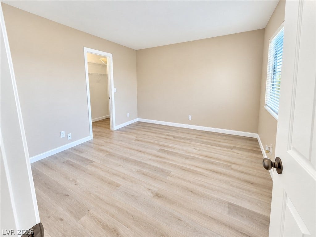 1417 Santa Margarita Street, #G, Las Vegas, NV 89146 Smooth new vinyl-flooring pairs with neutral-toned walls and an attached walk-in closet.