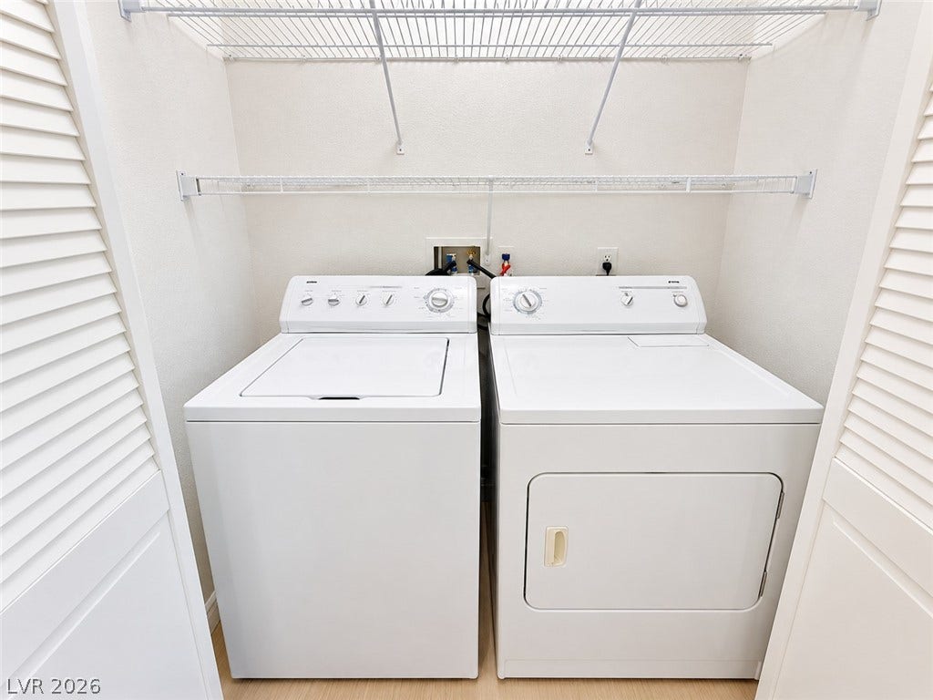 1417 Santa Margarita Street, #G, Las Vegas, NV 89146 Functional laundry closet equipped with wire shelving and side-by-side appliances.