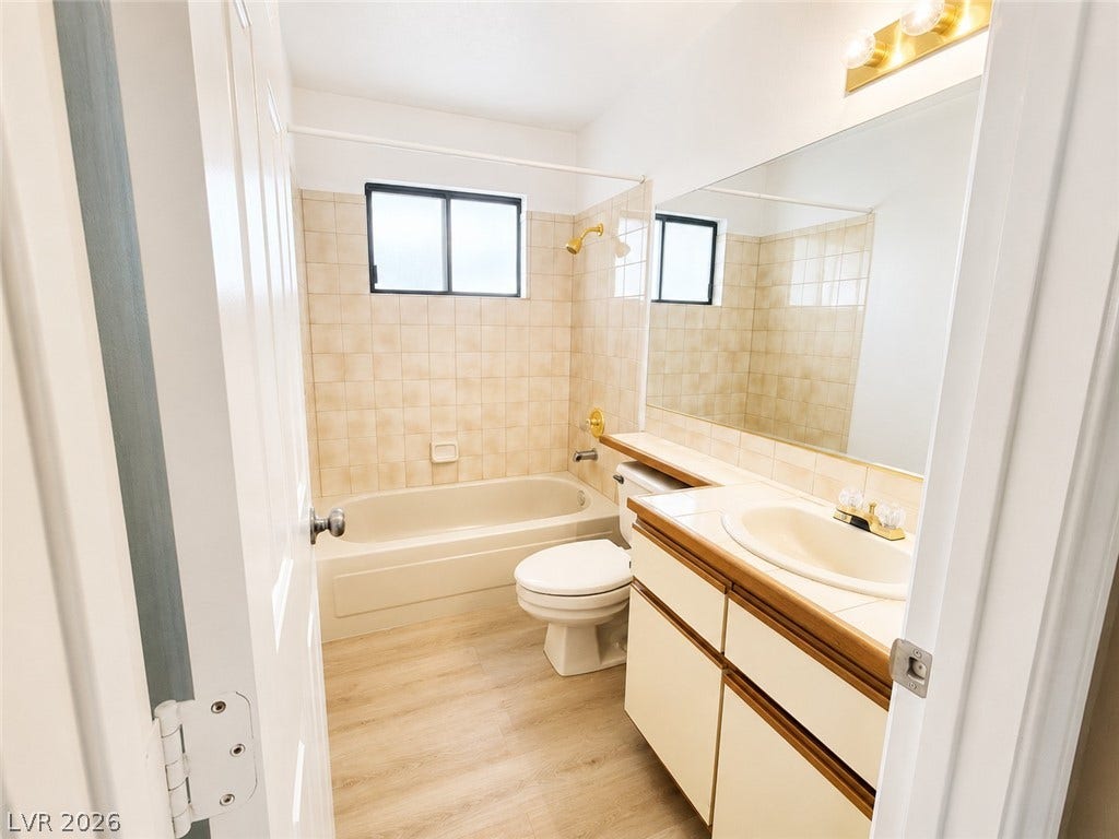 1417 Santa Margarita Street, #G, Las Vegas, NV 89146 A well-maintained bathroom features light-toned -look new vinyl flooring ,new toilet and a tiled shower tub combination.