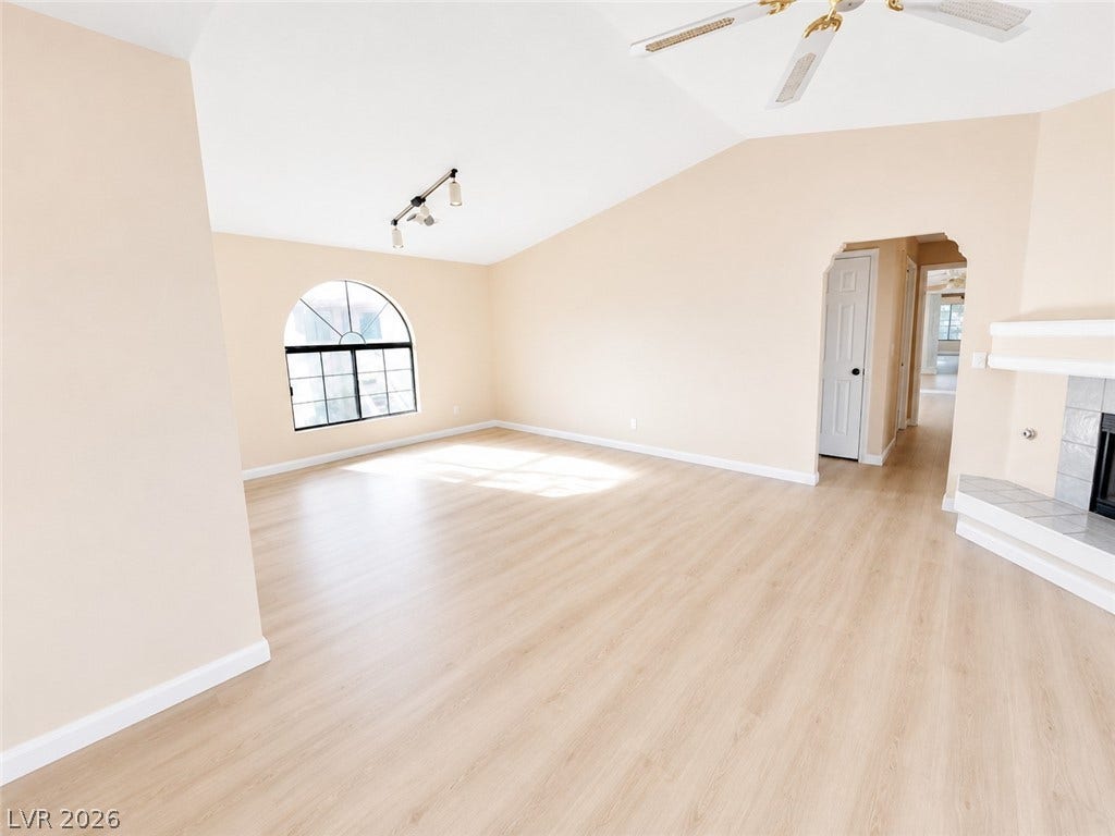 1417 Santa Margarita Street, #G, Las Vegas, NV 89146 Vaulted ceilings and vinyl flooring enhance this light-filled room with an arched window.