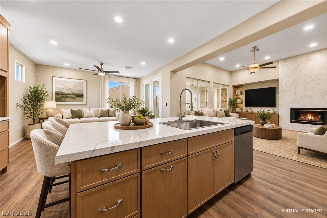 9613 Cherry Canyon Avenue, Las Vegas, NV 89129 An open floor plan integrates the spacious kitchen with the living areas over warm wood floors.
