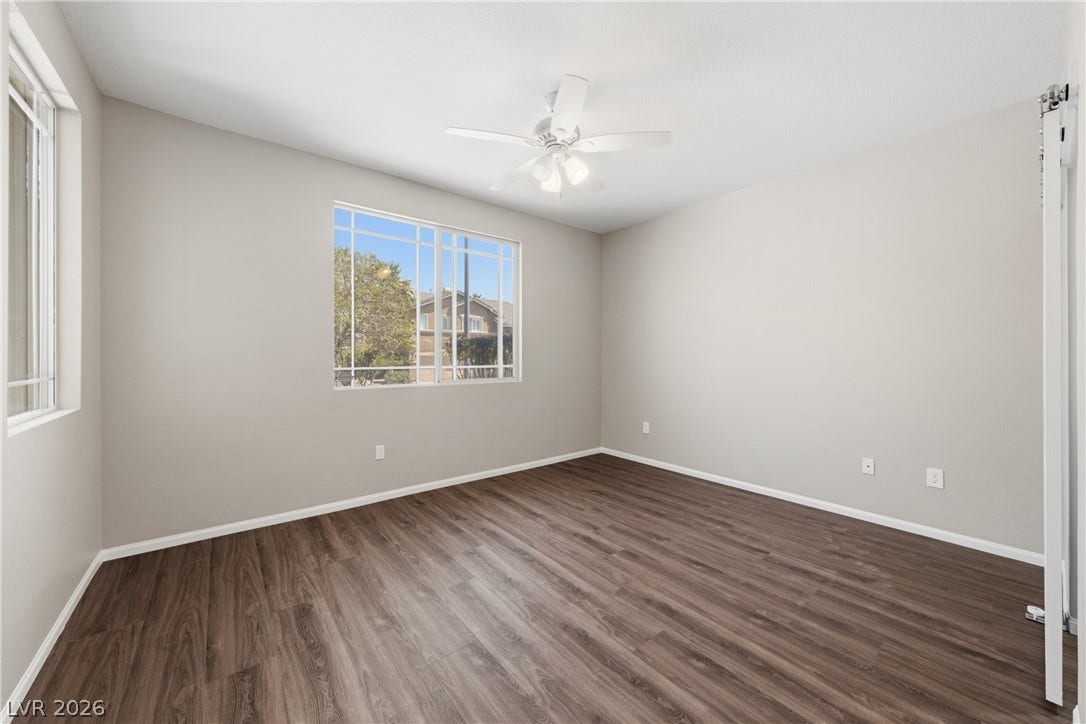 9613 Cherry Canyon Avenue, Las Vegas, NV 89129 Rich wood-inspired flooring and ample natural light define this versatile room.