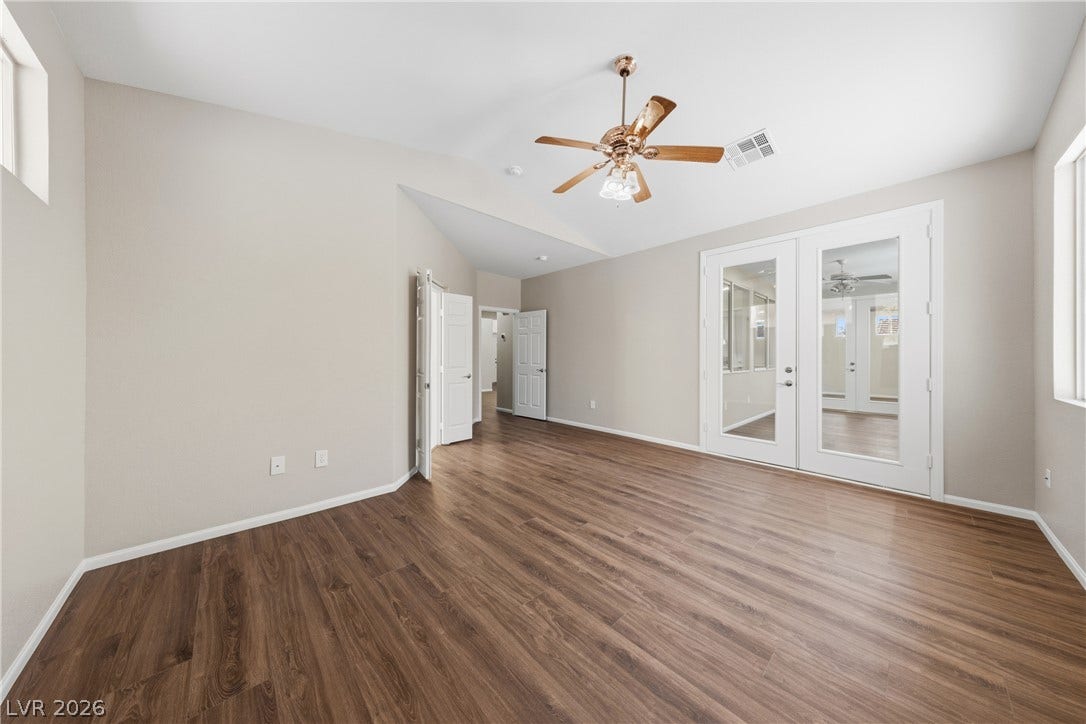 9613 Cherry Canyon Avenue, Las Vegas, NV 89129 Gleaming wood floors pair with a vaulted ceiling and classic French doors.