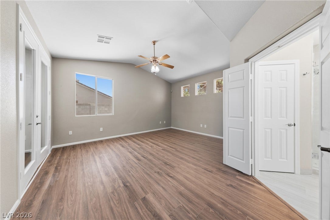 9613 Cherry Canyon Avenue, Las Vegas, NV 89129 Vaulted ceilings and wood-look flooring enhance this spacious bedroom suite.