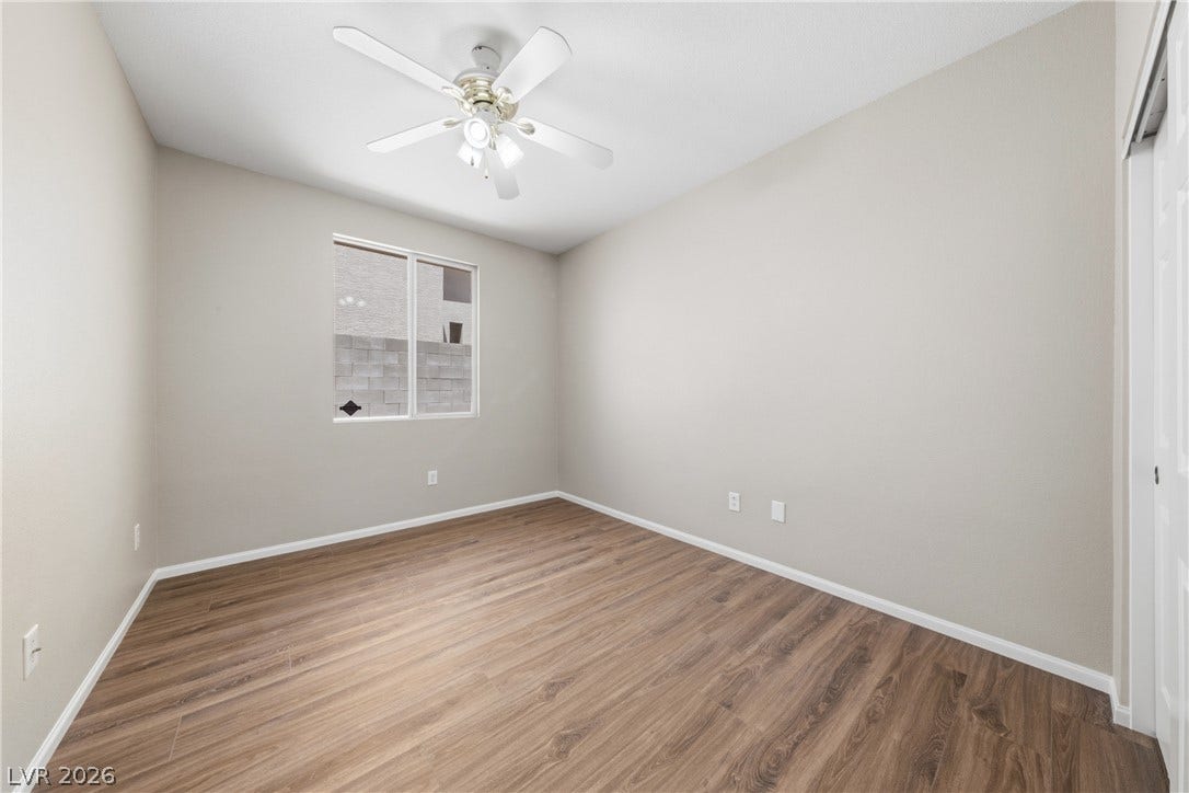 9613 Cherry Canyon Avenue, Las Vegas, NV 89129 Rich wood-inspired flooring pairs beautifully with neutral walls in this versatile bedroom space.