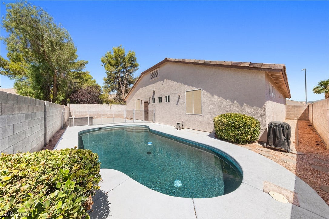 9613 Cherry Canyon Avenue, Las Vegas, NV 89129 A sparkling in-ground pool serves as the centerpiece of this secure, wall-enclosed backyard space.