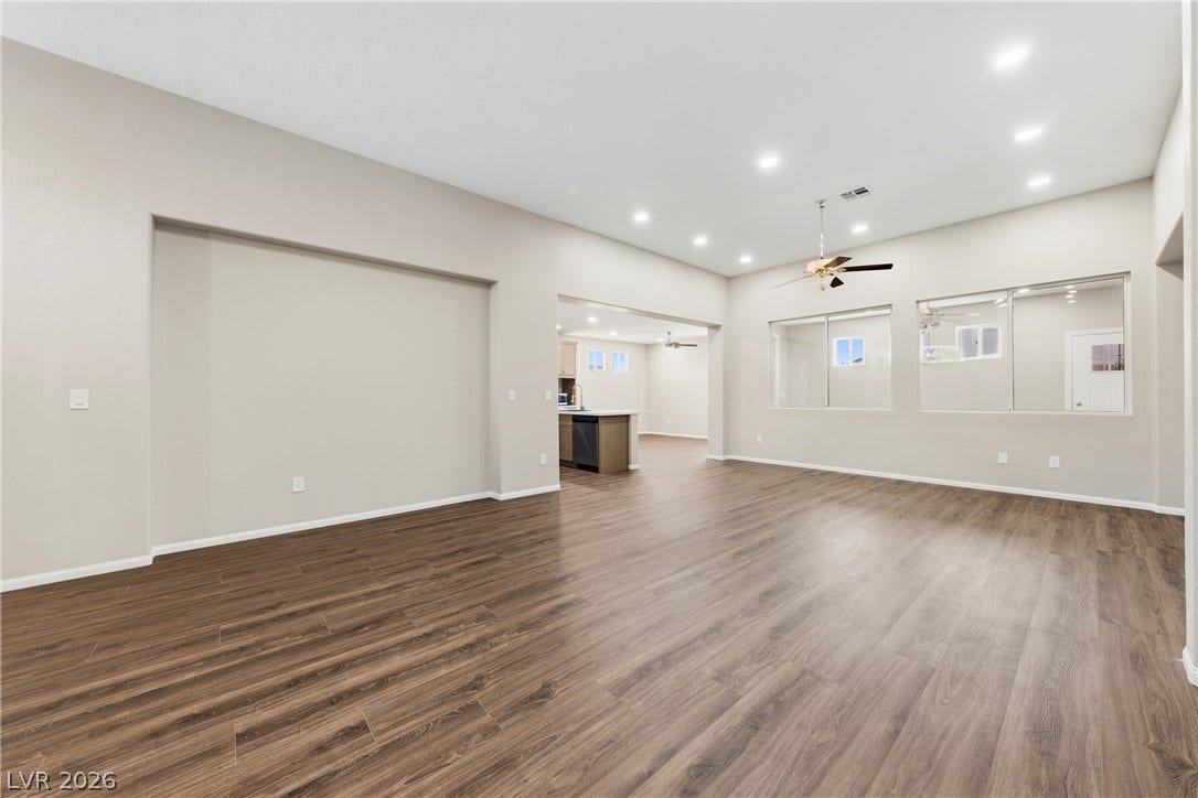 9613 Cherry Canyon Avenue, Las Vegas, NV 89129 Rich wood-look flooring and recessed lighting define this versatile, open-concept living space.