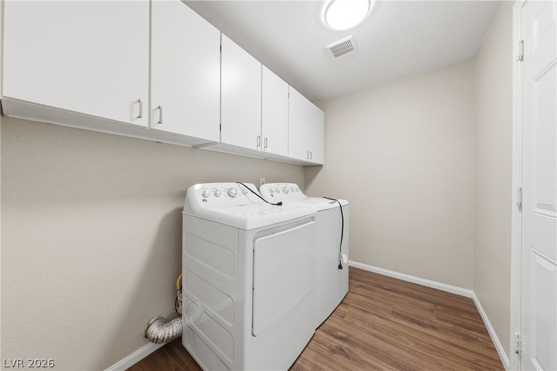 9613 Cherry Canyon Avenue, Las Vegas, NV 89129 Ample overhead cabinetry maximizes storage in this streamlined laundry space.