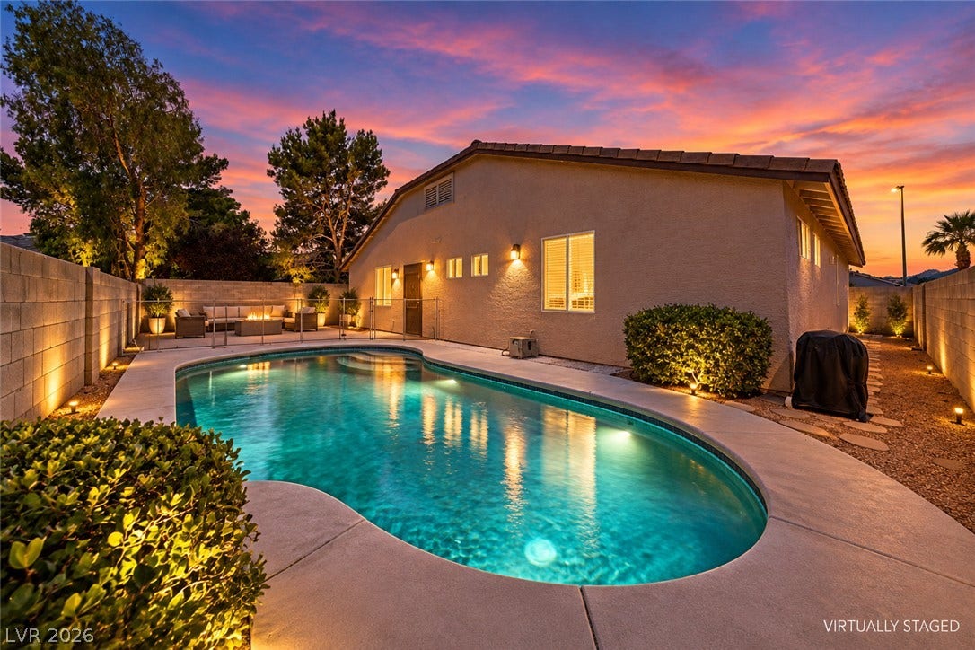 9613 Cherry Canyon Avenue, Las Vegas, NV 89129 A sparkling in-ground pool anchors this private backyard under a vibrant sunset sky.