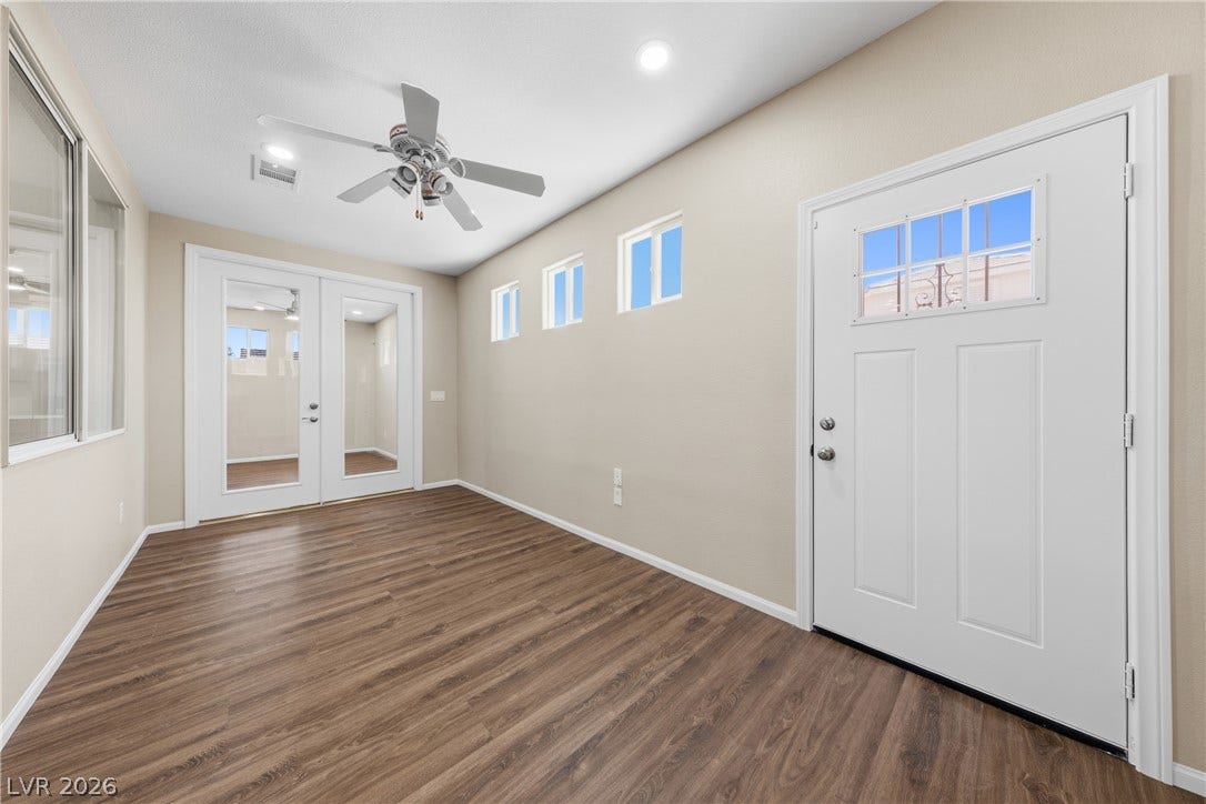 9613 Cherry Canyon Avenue, Las Vegas, NV 89129 Warm wood-look flooring sets an inviting tone in this versatile front entry space.