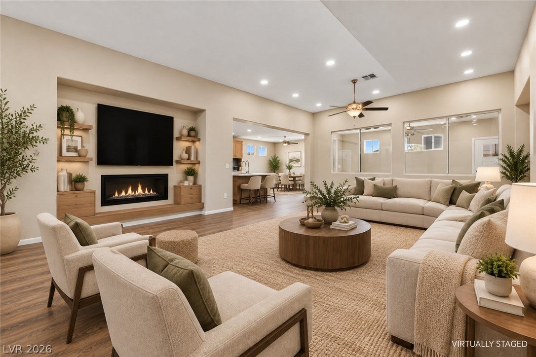 9613 Cherry Canyon Avenue, Las Vegas, NV 89129 A modern fireplace and recessed lighting elevate this spacious open-concept living area.
