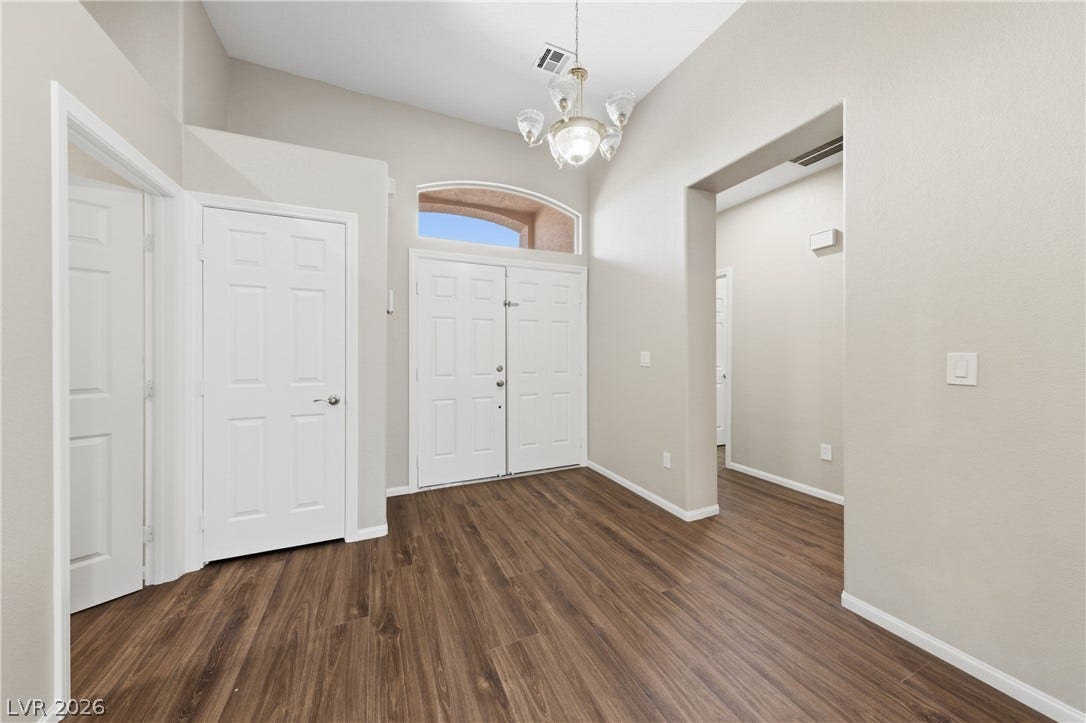 9613 Cherry Canyon Avenue, Las Vegas, NV 89129 A spacious entryway welcomes guests with soaring high ceilings and rich wood flooring.