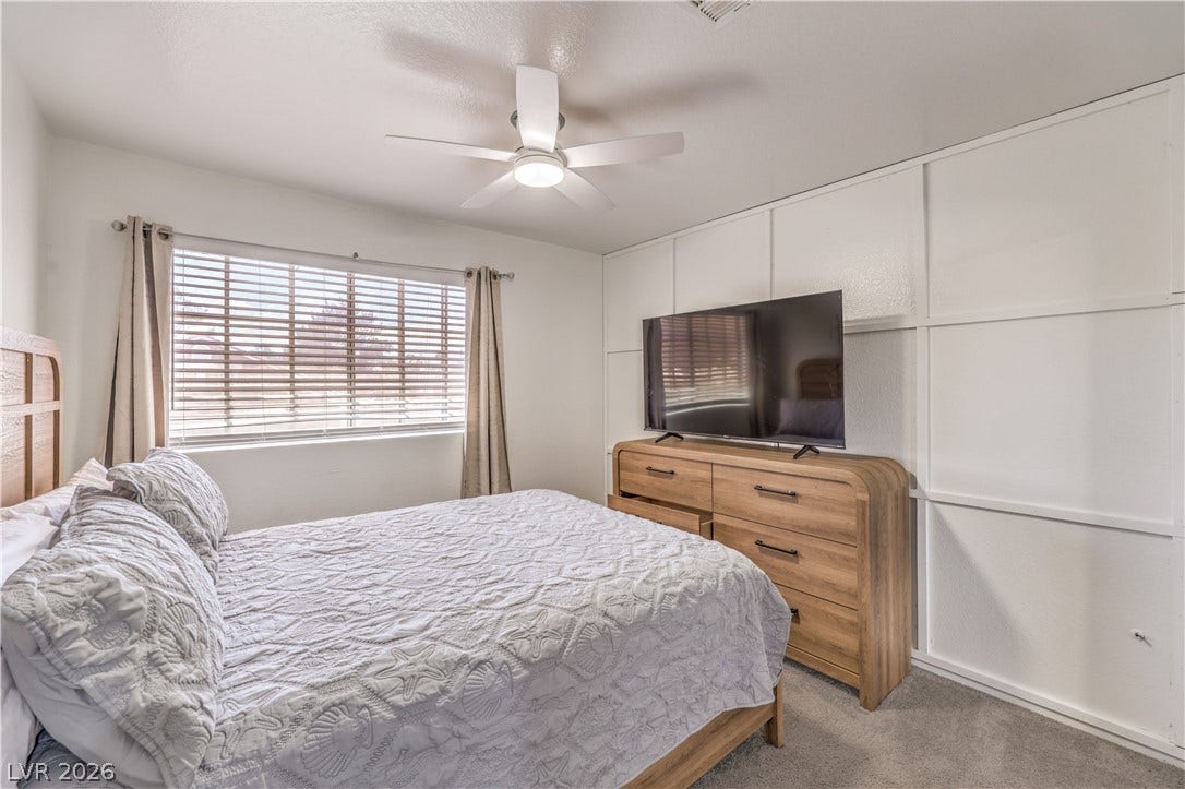 Board and batten accent detailing complements clean modern flooring in this comfortable sleeping space.