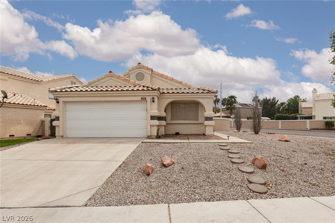 352 Lander Drive, Henderson, NV 89074 Tiled rooflines and low-maintenance desert landscaping define the exterior of this single-story stucco home.