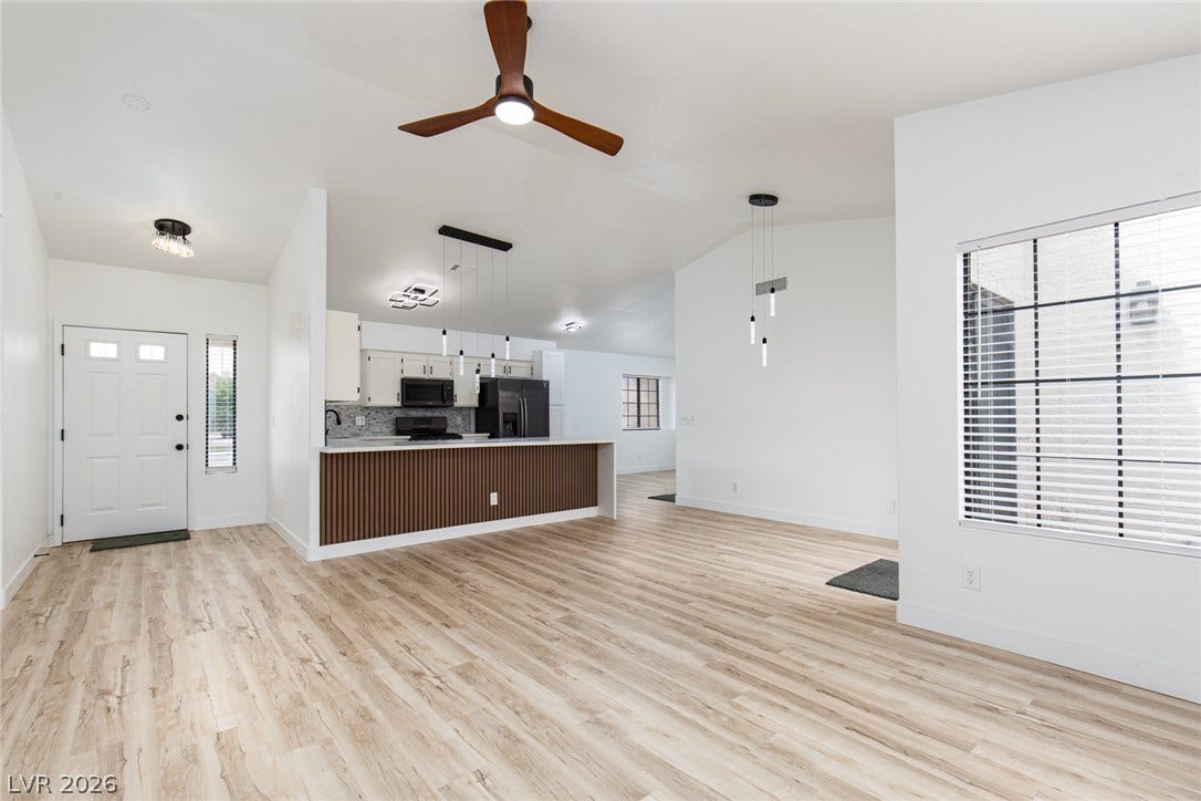 352 Lander Drive, Henderson, NV 89074 An open-concept living area flows seamlessly into the kitchen with modern wood-look flooring throughout.