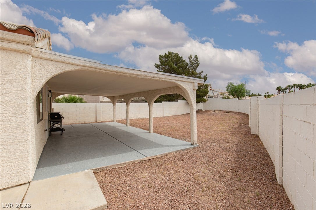 352 Lander Drive, Henderson, NV 89074 An arched covered patio provides a shaded outdoor retreat looking out over the fenced yard.