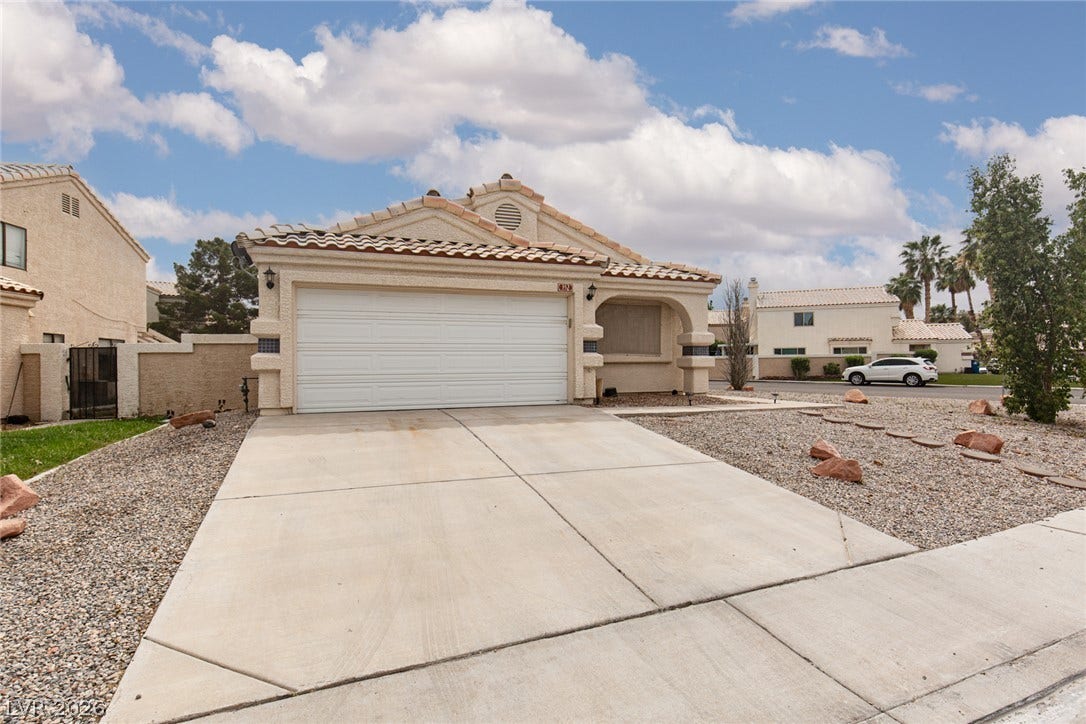 352 Lander Drive, Henderson, NV 89074 Spanish tile roofing and a concrete driveway define this classic suburban exterior.