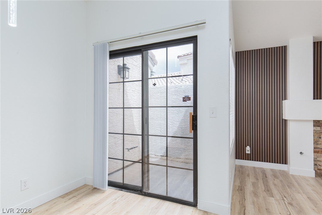 352 Lander Drive, Henderson, NV 89074 Sliding glass doors open directly to a private courtyard under high ceilings.
